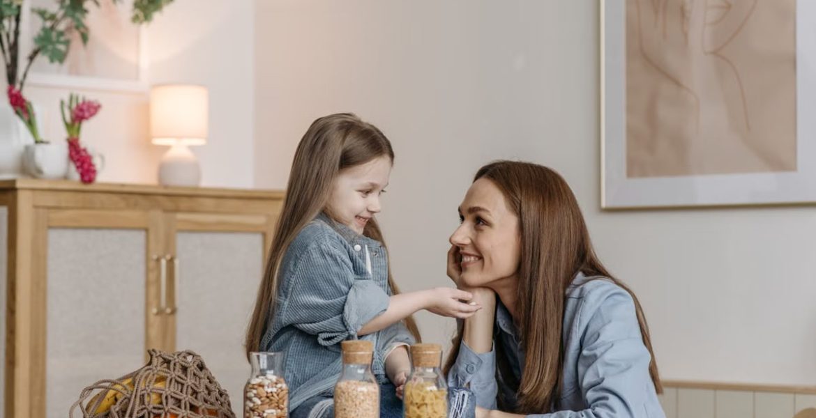 A loving mother and daughter enjoying quality time together in a cozy kitchen setting.